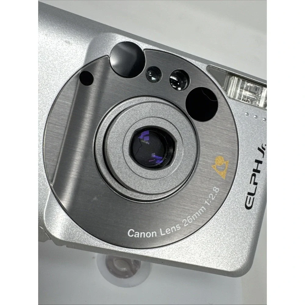 CANON Elph Jr. APS Film Camera, 26mm‎ f2.8 Wide Angle Lens, Silver w/ Case WORKS